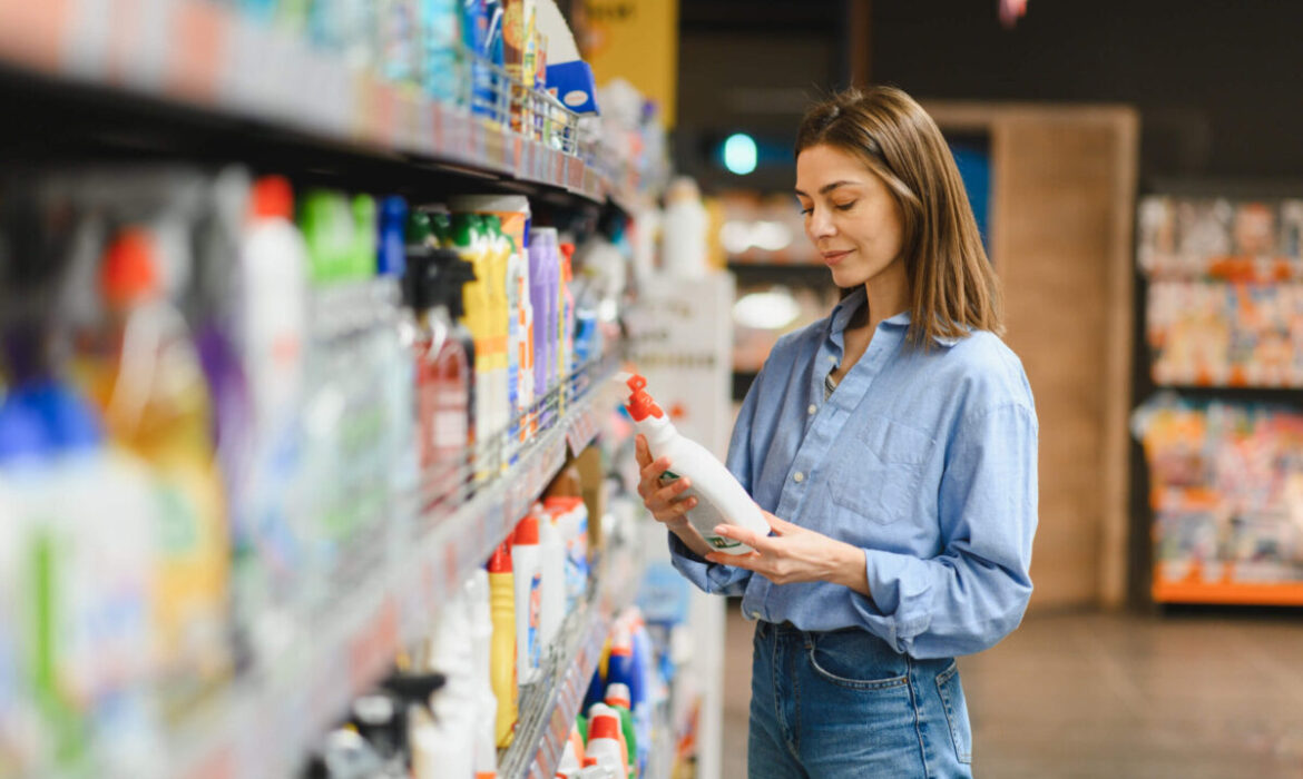 A shopper comparing products while making a purchase decision in a retail store.